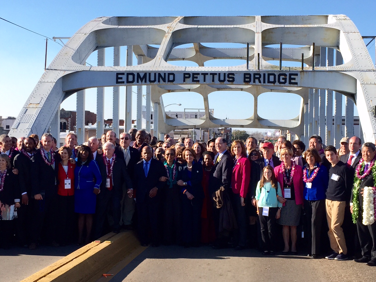 Members of Congress walk across the Edmund Pettus Bridge